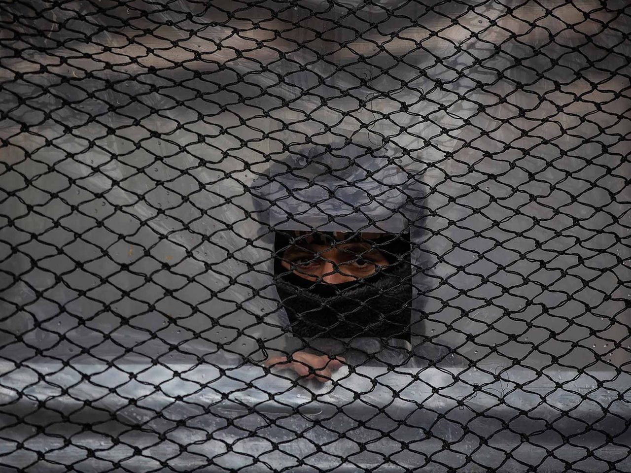 An Indian paramilitary soldier guard inside his post at a closed market in Srinagar, Indian controlled Kashmir, Wednesday, Jan. 26, 2022. Republic Day marks the anniversary of the adoption of the India's constitution on Jan. 26, 1950. This project documents ongoing unrest in the long-disputed region of Kashmir, dating back to 1947, when India and Pakistan gained independence from Britain. Both nations claim Kashmir in its entirety, and each administers a portion of the region. In Indian-administered Kashmir, rebels have been fighting Indian rule for decades, seeking to unite the territory, either under Pakistani rule or as an independent country. India says that Pakistan supports armed insurgency in Kashmir. Pakistan denies the charge, saying it provides moral and diplomatic support only.